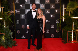 Former player Matt de Boer is joined by his wife Rachael Glaskin in a sleek, black sparkly gown. They are matching perfectly.  (AAP: Joel Carrett)