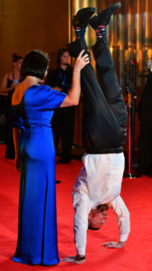 2001 Brownlow medallist Jason Akermanis decides there is no better way to show off your fun little socks than with a handstand.  (Getty Images: Josh Chadwick)